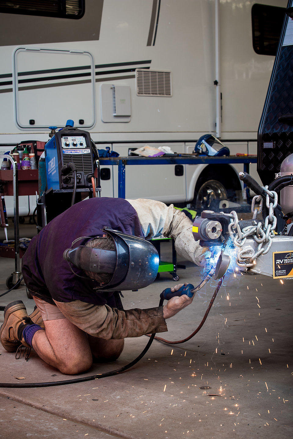 RV Service Centre staff member repairing a caravan