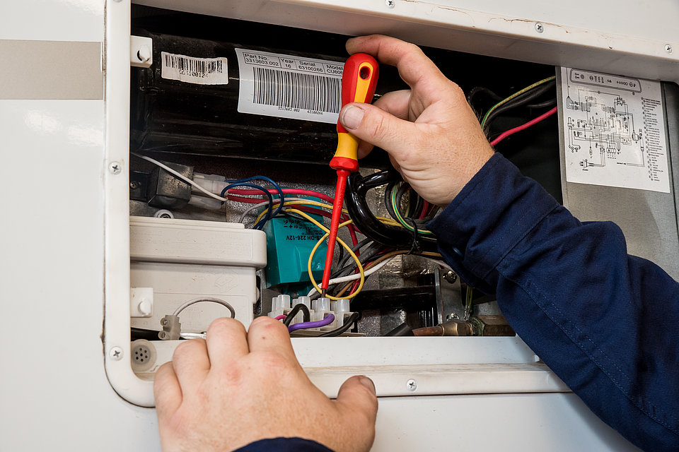 RV Service Centre technician working on caravan