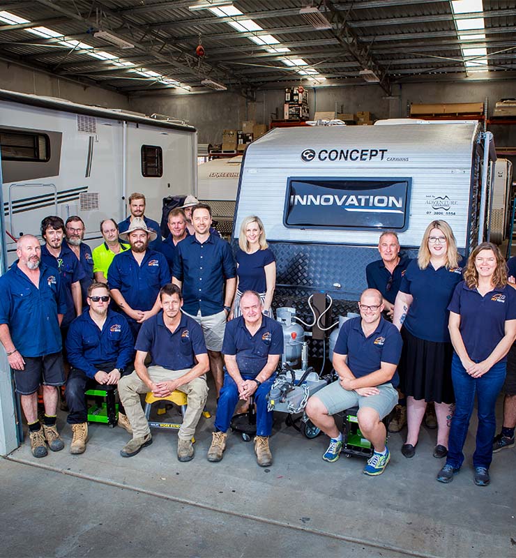 The RV Service Centre team in front of a caravan