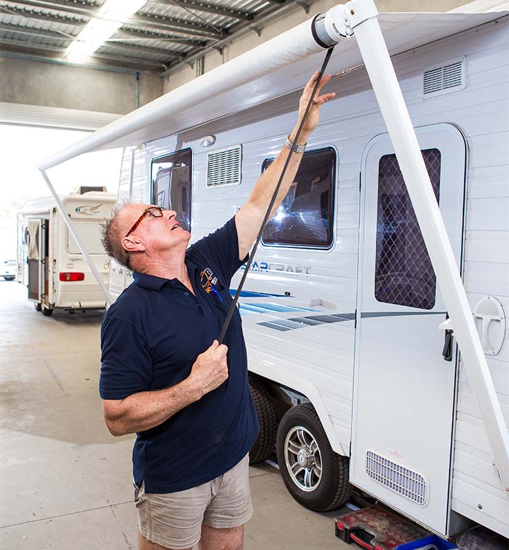 RV Service Centre technician repairing awning on a caravan