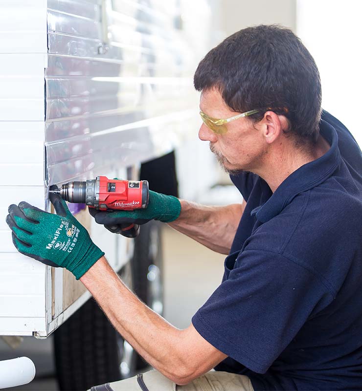 RV Service Centre technician resheeting a caravan